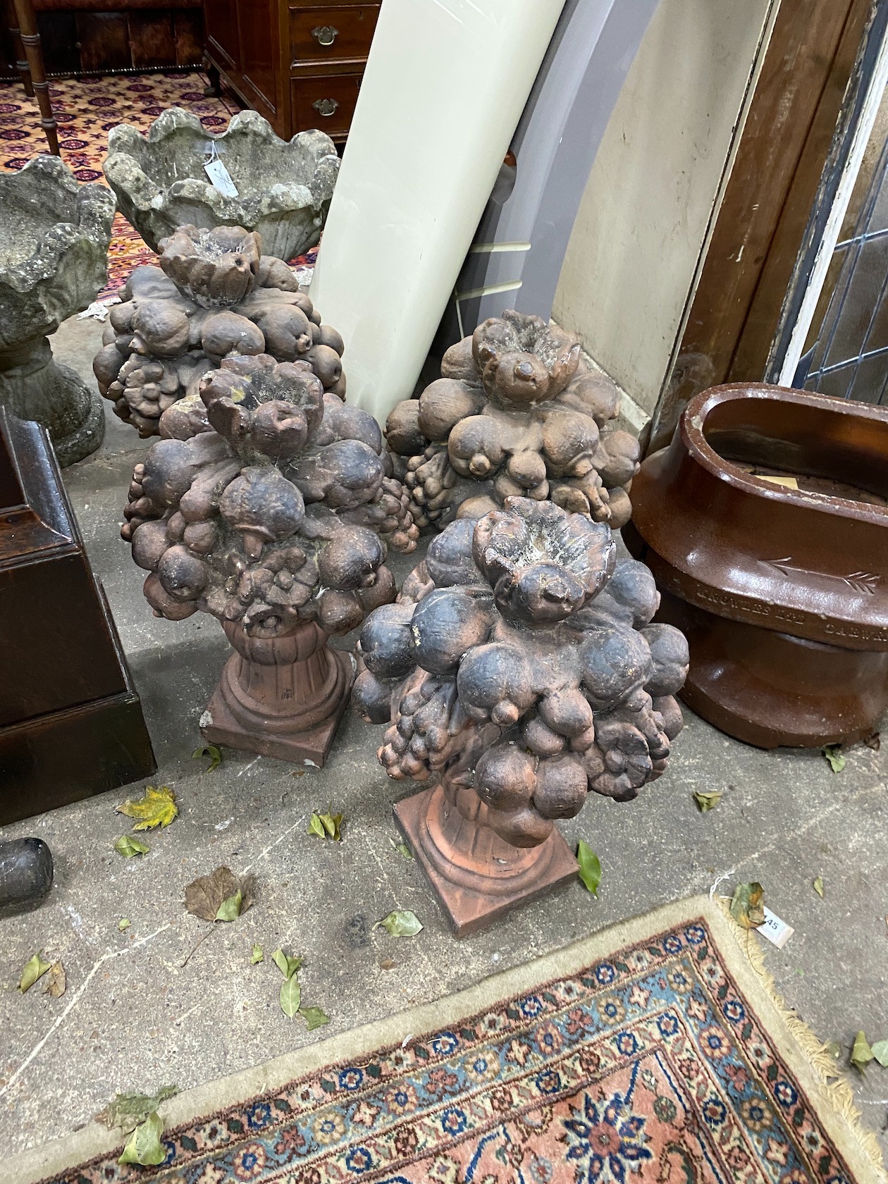 A set of four earthenware fruiting vase finials, possibly Lefco Ware, height 56cm